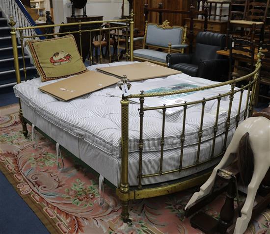 A Victorian brass double bedstead, with tubular headrails and uprights, chased with flowerheads and surmounted by W.170cm, L.214cm with